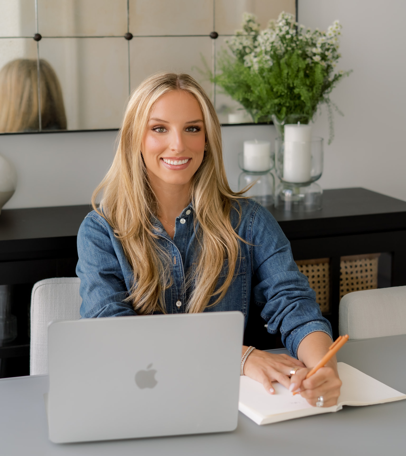 Amanda Fogel Harwood, LMHC, seated at a desk with a notebook and laptop